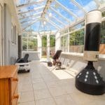 Bright conservatory with fitness equipment.