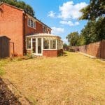 Sunny garden with a brick house