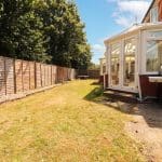 Garden with conservatory and fencing.